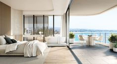 a bedroom with large windows overlooking the ocean