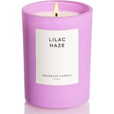 a purple candle with a label that says lilac haze on the front and side