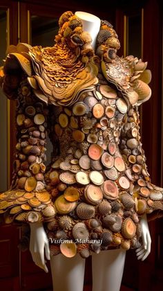 a mannequin made out of wood and shells