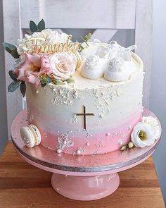 a cake decorated with flowers on top of a wooden table next to a white chair