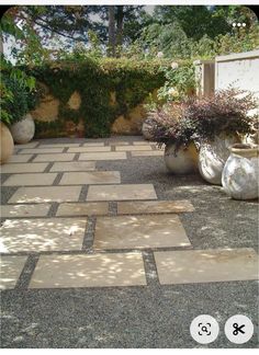 an outdoor patio with potted plants and gravel