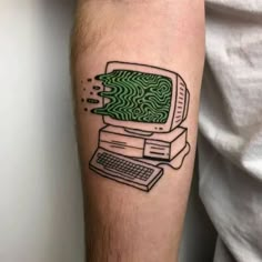 a man's arm with a computer tattoo on it