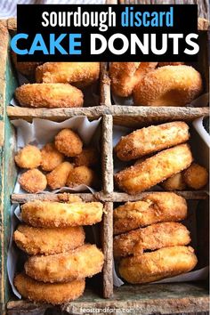 a box filled with doughnuts sitting on top of a wooden table