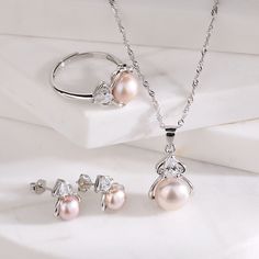 Style: Women Fashion Material: S925 Sterling Silver Pearl Type: Freshwater Pearl Pearl Color: White & Pink Pearl Size: 7mm 7.5mm 9mm Pendant Size: 2.3*1.2cm Necklace Length: 40+5cm Earrings Size: 2*1cm Ring Size: Adjustable Elegant Pink Sterling Silver Jewelry Sets, Elegant Rose Gold Sterling Silver Jewelry Sets, Sterling Silver Jewelry Sets For Her, Sterling Silver Round Jewelry Sets As Gift For Her, Sterling Silver Jewelry Sets As Gift For Her, Pink Pearl Necklace, Pearl Necklace Earrings, Pearl Types, Pearl Pendant Necklace