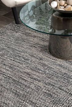 a glass table sitting on top of a rug