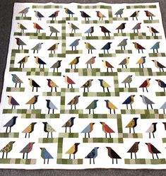 a quilt with many birds on it