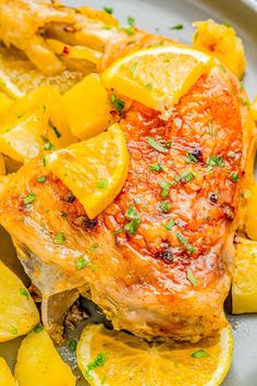 a close up of food on a plate with lemons