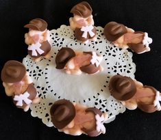 chocolate candies are arranged on a doily