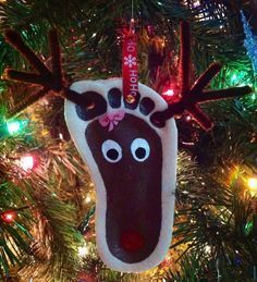 a reindeer ornament hanging from a christmas tree