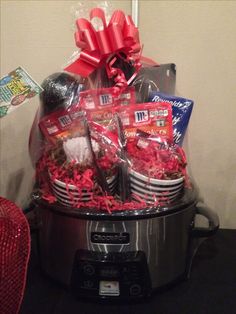 a crock pot filled with lots of goodies on top of a black table