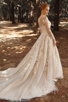 a woman wearing a wedding dress in the woods