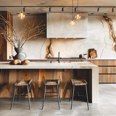 a kitchen with marble counter tops and stools