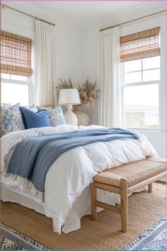 a bed with blue and white comforters in a bedroom