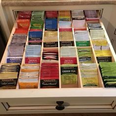 a drawer filled with lots of different types of teas on top of each other