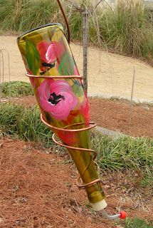 a colorful vase sitting on top of a grass covered field