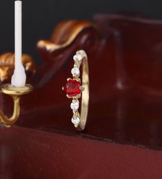 a close up of a ring with a candle in the background