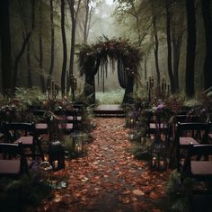 an outdoor ceremony set up in the woods with candles and flowers on the aisle, surrounded by trees