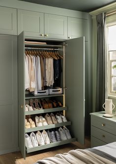 an open closet with shoes and other items in it