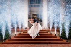 a bride and groom are kissing on the steps