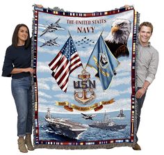 two people standing next to a blanket with an image of the united states navy on it