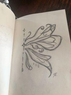 an open book with a drawing of a flower