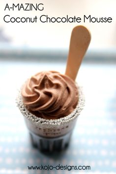 a chocolate mousse in a cup with a wooden spoon on the top and text overlay that reads, a - amazing coconut chocolate mousse