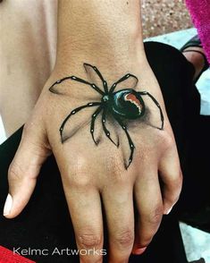 a hand with a spider tattoo on it