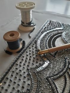 two spools of thread sitting on top of a table