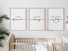 three framed art prints on the wall above a crib