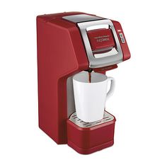 a red coffee maker with a white cup