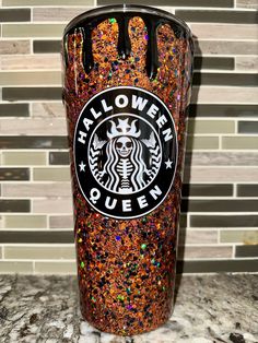 the starbucks cup is decorated with colorful glitters