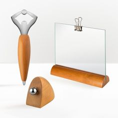 a wooden object with a glass holder and scissors on the top, next to it