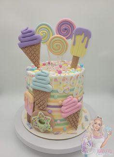 a cake decorated with ice cream, lollipops and candy