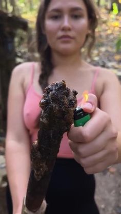 a woman holding a lighter in her hand