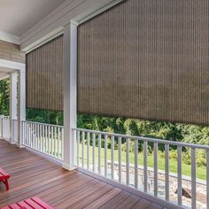 a porch with two red benches on it and an awning over the deck area