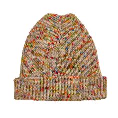 a knitted beanie hat with multicolored dots on the front and sides