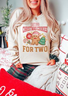 "🎄Celebrate the most wonderful news of the year with our \"Eating Christmas Cookies for Two\" pregnancy announcement sweatshirt - the coziest and most festive way to share your joyous news this holiday season! Adorned with a heartwarming design, this XMas maternity sweater is not only a perfect gender reveal jumper but also an adorable new mom baby gift. Capture the magic of the season and make your announcement extra special by ordering yours today! 👕 PRODUCT INFO This classic unisex long sleeve tee fits like a well-loved favorite. Casually elegant with an excellent quality print, it is an irreplaceable everyday item for anyone. * Medium-heavy fabric (8.0 oz/yd² (271.25 g/m * Loose fit * Runs true to size * 50% cotton, 50% polyester ✏️ DESIGN Designs are printed onto the shirt using Dir Holiday Gender Reveal, Cookies For Two, Second Pregnancy Announcements, Christmas Maternity, Family Christmas Outfits, Queen Tee, Grey Pictures, Christmas Pregnancy, Christmas Rock