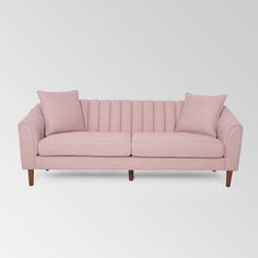 a pink couch with two pillows on the back and one arm folded up in front