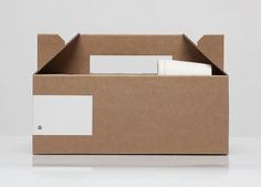 an open cardboard box with some papers in it