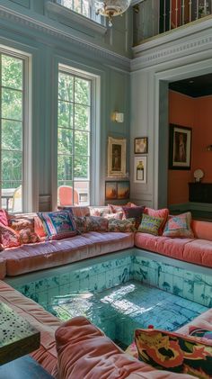 a living room filled with lots of furniture next to a swimming pool