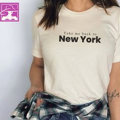 a woman wearing a t - shirt with the words take me back to new york on it