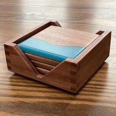 a wooden desk with a blue napkin holder