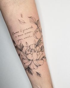 a woman's arm with flowers on it and a quote written in cursive writing