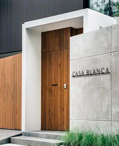 an entrance to a building with wooden doors