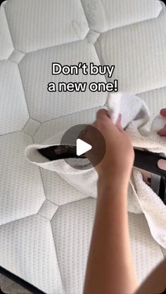 someone is cleaning the mattress with a cloth