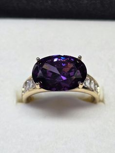 Beautiful large stone simulated amethyst and diamond gold plated ring  Sizes L & N The gold is 14ct  Such a show stopper very sparkly  You will not be disappointed  Please look at my other listing  Thank you Dazzling Purple Rings With Prong Setting, Dazzling Purple Ring With Prong Setting, Gold Amethyst Ring With Vvs Clarity, Gold Amethyst Ring With Accent Stones, Dazzling Purple Oval Rings, Gold Amethyst Jewelry With Accent Stones, Gold Amethyst Ring With Accent Stones, Round Cut, Gift Amethyst Ring With Vvs Clarity, Purple Oval Jewelry With Diamond Accents