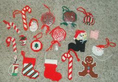 knitted christmas ornaments laid out on the floor with candy canes and candies