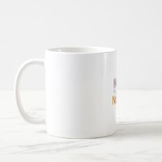 a white coffee mug sitting on top of a table