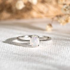 A simple opal ring with a dainty silver band…but it’s anything but ordinary! With its iridescent rainbow hues and four-prong setting, this stunning ring will add a magical glow to your stacks.

Opal stone measures at 7x5 mm.
 Size: 4, 5, 6, 7, 8, 9, 10 Luxury Minimalist Opal Ring, Simple Opal Ring, Opal Ring Simple, Opal Wedding Ring Set, Opal Ring Silver, Moonstone Engagement Ring Rose Gold, Opal Band Ring, Promise Rings Simple, Raw Opal Ring