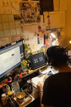 a woman sitting at a desk in front of a computer